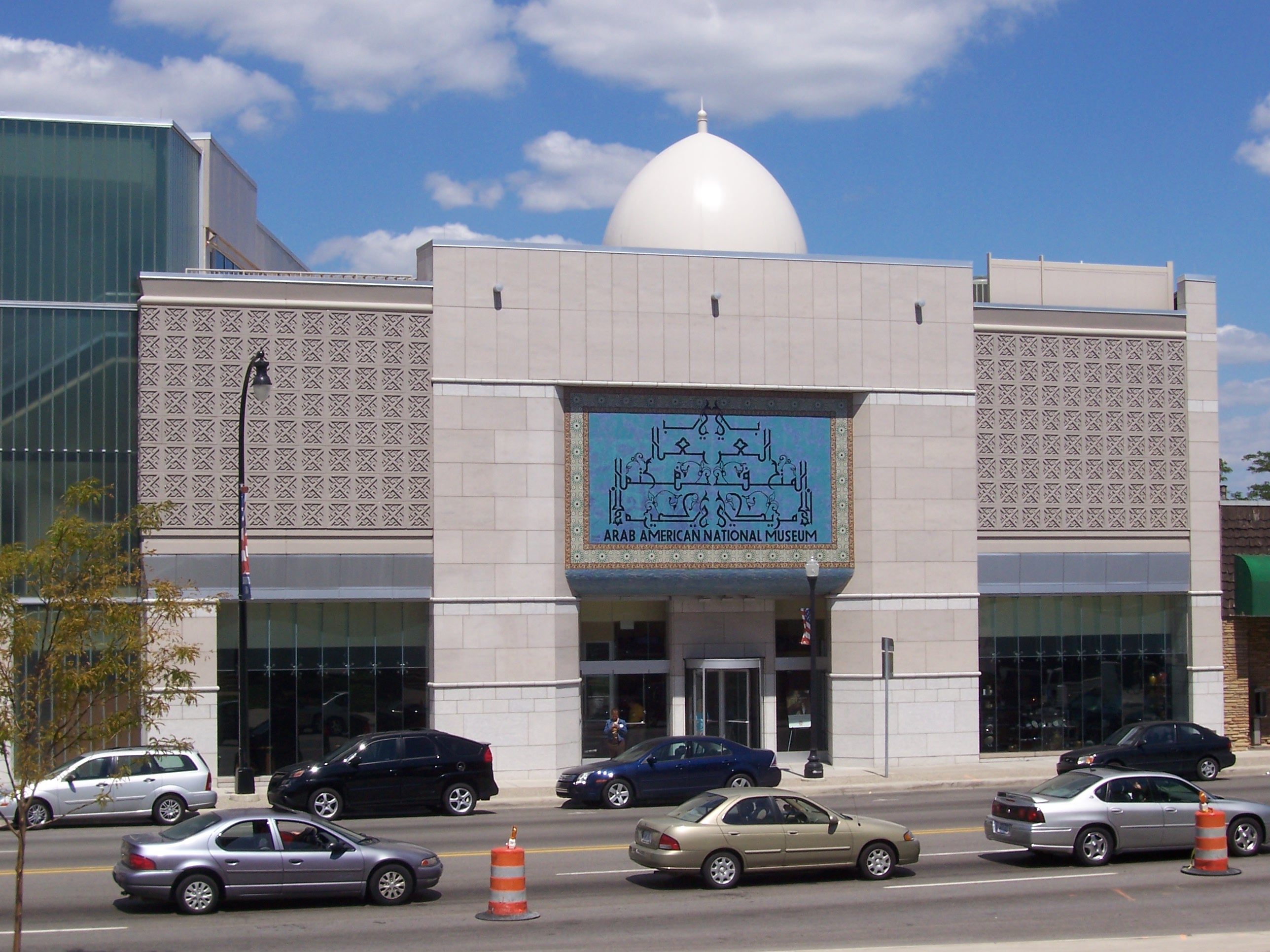 The Arab American National museum facade made of white stone with a dome