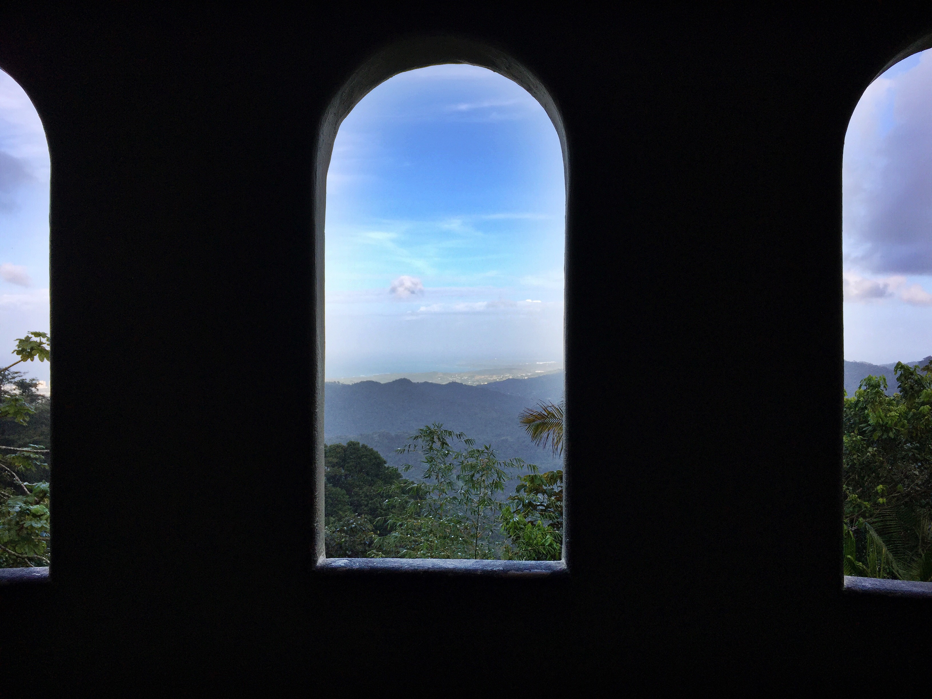 View of the El Yunque Rainforest through an arched window of a tower