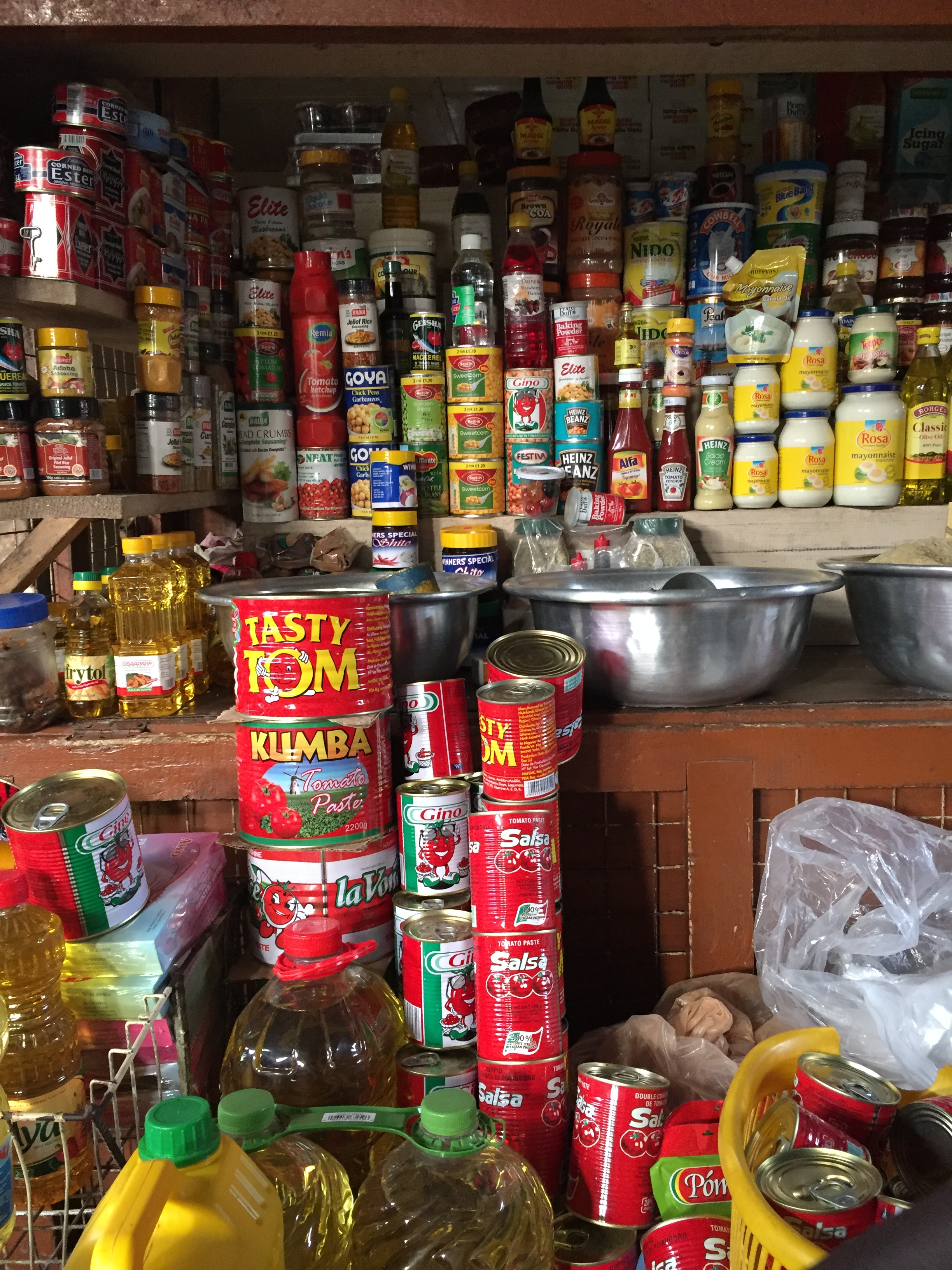 stacks of canned goods such as tomato paste, oil, ketchup, mayonnaise, powered milk and spice
