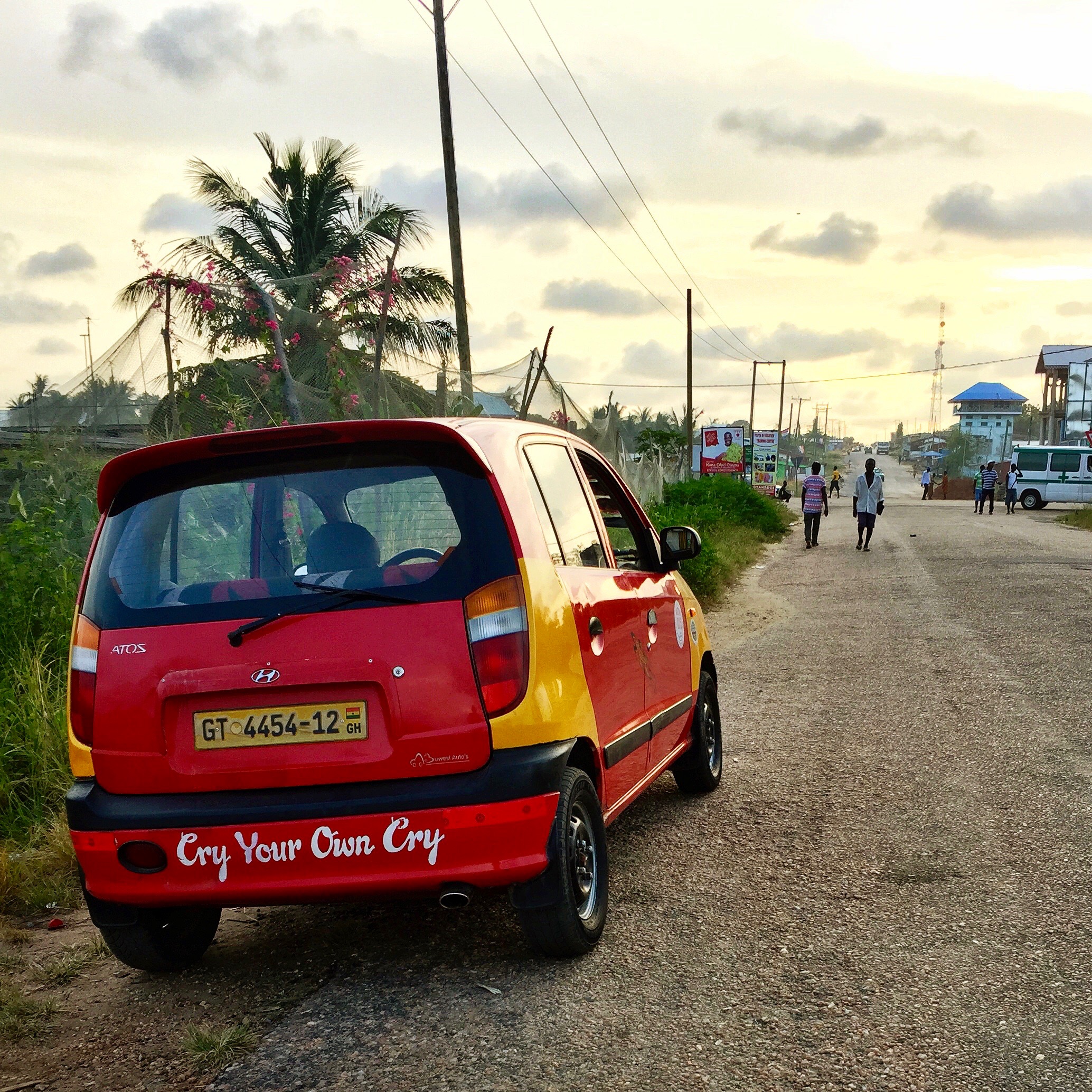 A red Hyundai Atos with Cry Your Own Cry painted on the bumper